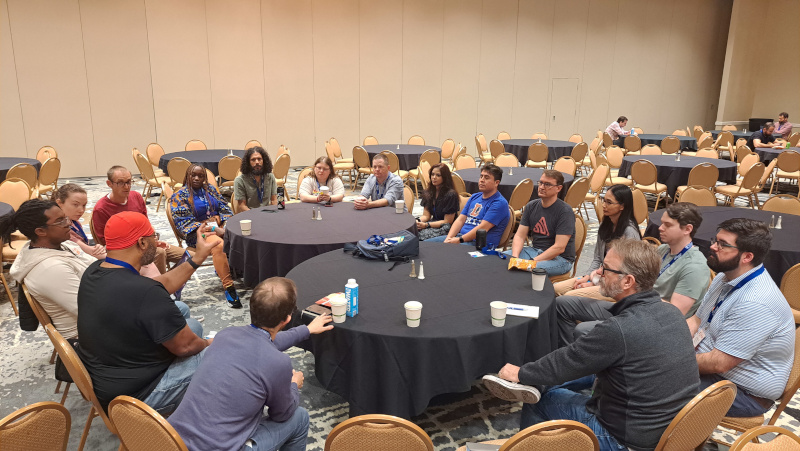 A circle of Django developers chatting about maintaining open-source software at DjangoCon US in Durham, NC.