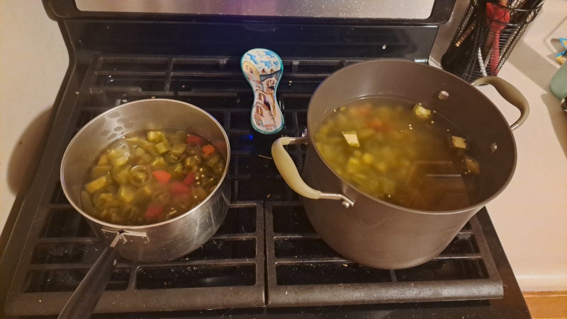 The kettles full of the pepper brine simmer on the stove top.